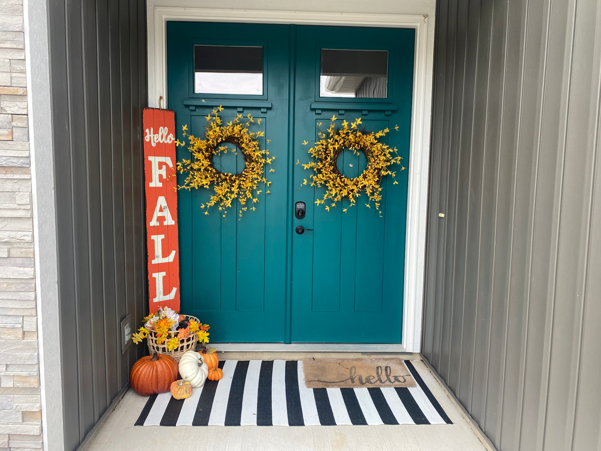 Front entryway before — plain double doors and bare cedar trim