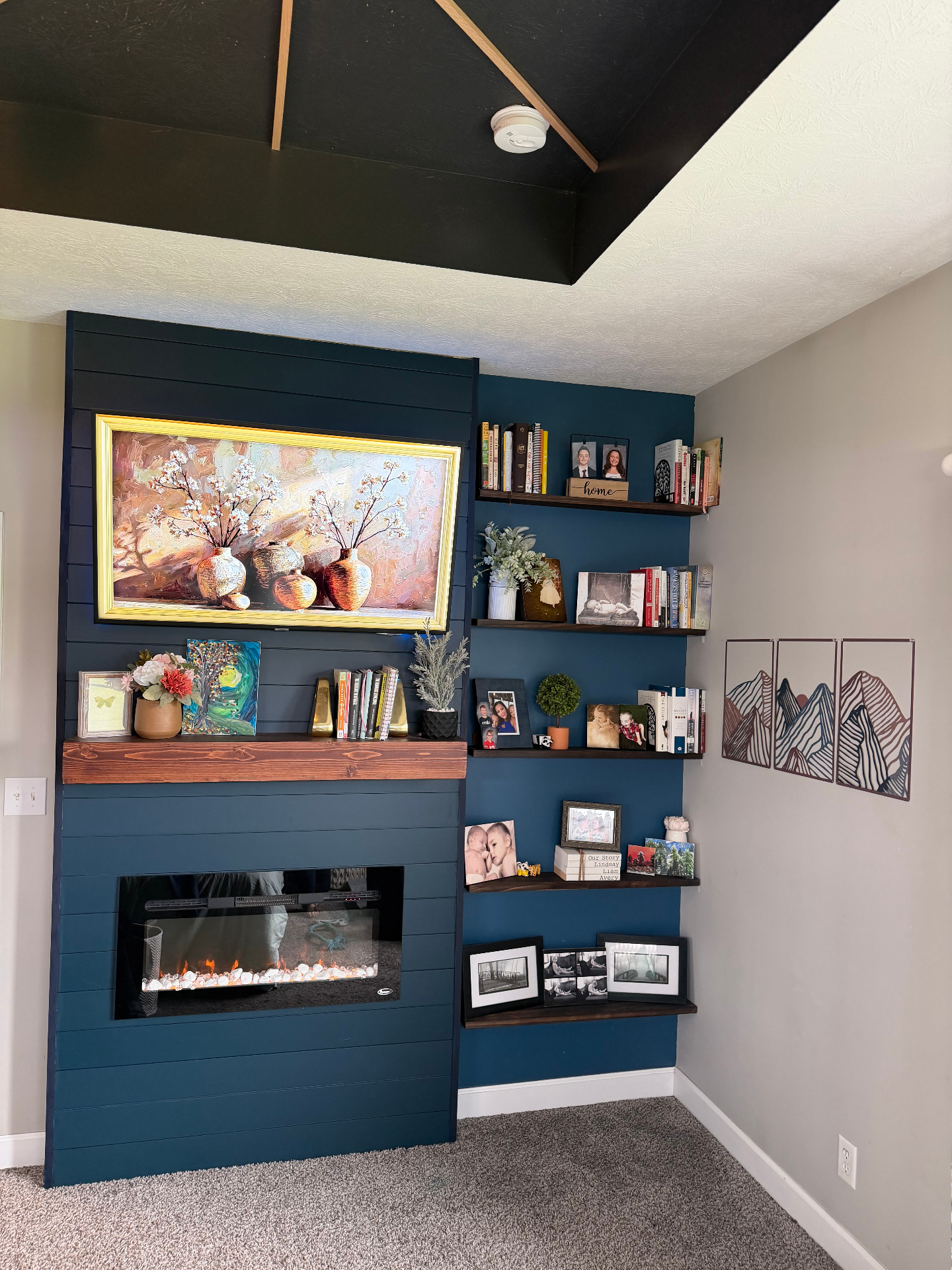 Master bedroom after — custom shiplap fireplace wall with mantle and floating shelves