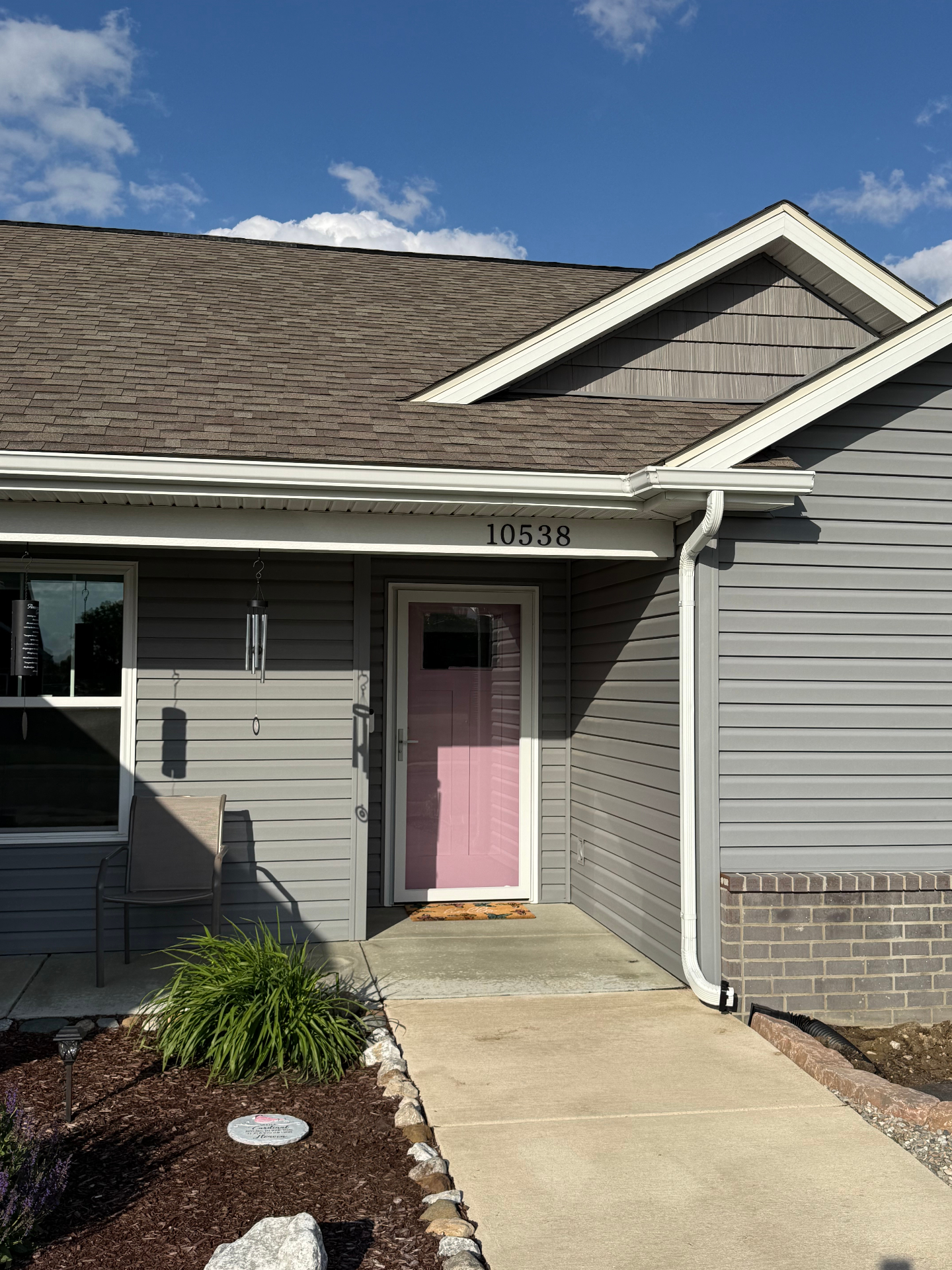 Front entry before — exposed pink front door with no storm door